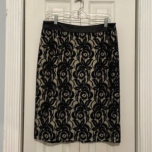 Ann Taylor black lace skirt over beige silky lining.